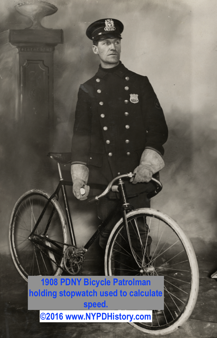 1908 Bicycle Patrolman holding stopwatch used to compute speed.